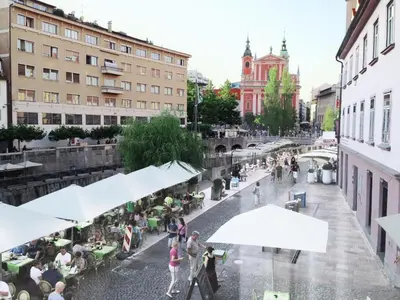a group of people walking around a city street at Studio Emmi in Ljubljana