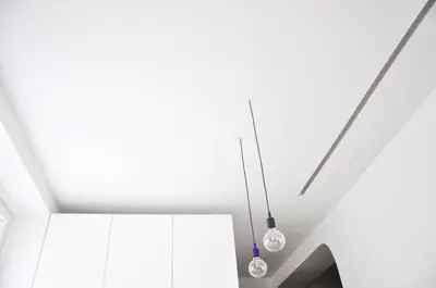 two lights hanging from the ceiling in a room at Studio Emmi in Ljubljana