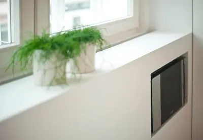 a window sill with two potted plants on it at Studio Emmi in Ljubljana