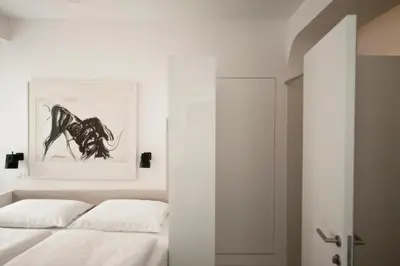 a bedroom with a bed and a painting on the wall at Studio Emmi in Ljubljana