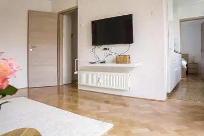 a living room with a flat screen tv on a wall at Bright Apartment in Ljubljana