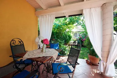 a patio with a table and chairs on a porch at Apartments Your Colourful Ljubljana Home in Ljubljana