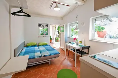 a bedroom with a bed and a desk in a room at Apartments Your Colourful Ljubljana Home in Ljubljana