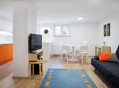 a living room with a couch and a table with chairs at Apartments Your Colourful Ljubljana Home in Ljubljana