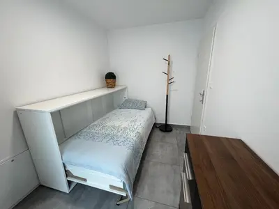 a small bedroom with a bed and a shelf at Apartma Rebolj in Moravske Toplice