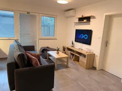 a living room with a couch and a tv at Apartma Rebolj in Moravske Toplice