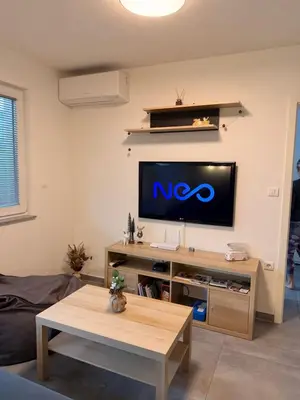 a living room with a flat screen tv on a wall at Apartma Rebolj in Moravske Toplice