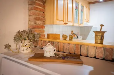 a kitchen counter with a tea kettle and vases on it at Studio Apartment Pr' Mirotu in Osilnica