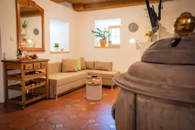 a living room with a couch and a table at Studio Apartment Pr' Mirotu in Osilnica