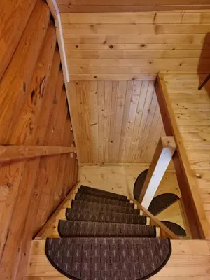 an inside view of a room with stairs in an attic at BRINA Pokljuka in Zgornje Gorje
