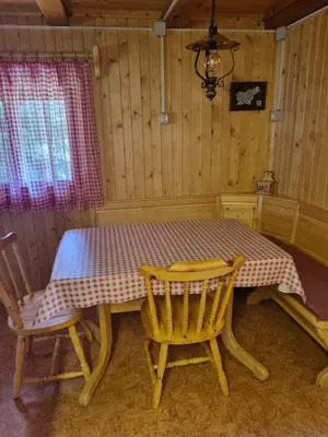 a table in a room with two chairs and a table with at BRINA Pokljuka in Zgornje Gorje