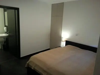 a bedroom with a bed and a light on the wall at Adrenalina in Krško