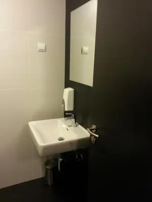 a bathroom with a white sink and a mirror at Adrenalina in Krško