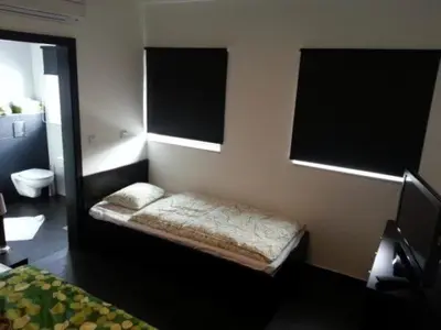 a small room with a bed in a bedroom at Adrenalina in Krško