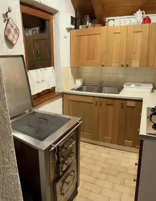 a kitchen with an oven and a sink at Vilijev Raj, a property with cottage in the countryside in Avče