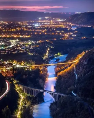 a view of a bridge over a river at night at Vilijev Raj, a property with cottage in the countryside in Avče