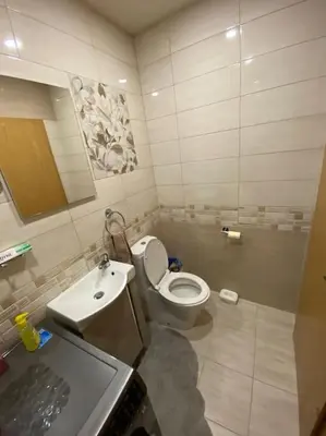 a bathroom with a toilet and a sink at Robert's Apartment in Celje