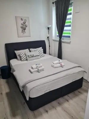 a bedroom with a large bed with towels on it at Aspen Studio Apartment + FREE Parking in Ljubljana