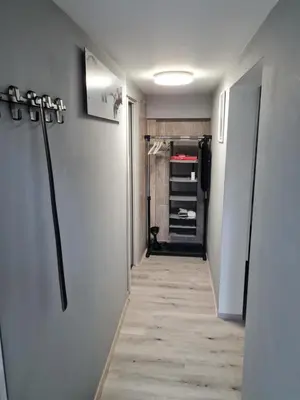 a hallway with a walk in closet with a door and a hallwayngthngthngth at Aspen Studio Apartment + FREE Parking in Ljubljana