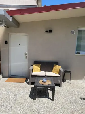 a living room with a couch and a table at Aspen Studio Apartment + FREE Parking in Ljubljana