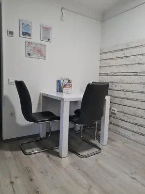 a white table and two chairs in a room at Aspen Studio Apartment + FREE Parking in Ljubljana