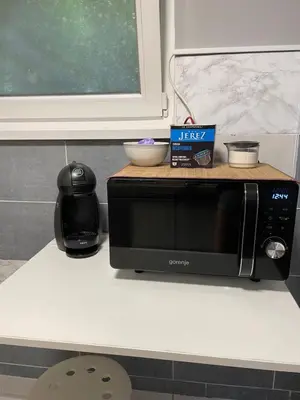 a microwave on a counter with a box on top of it at Aspen Studio Apartment + FREE Parking in Ljubljana