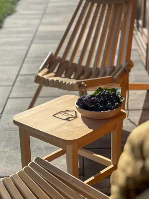 a bowl of fruit sitting on a table next to a bench at Hiška Erika - Wood House Erika in Šoštanj