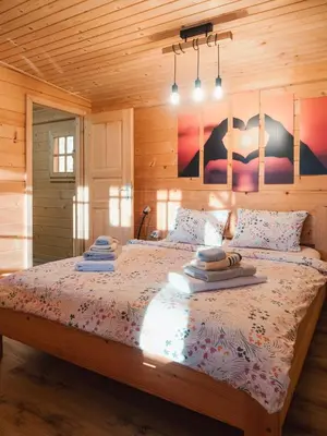 a bedroom with a bed with pillows on it at Hiska Na Samem v Slovenj Gradcu in Slovenj Gradec