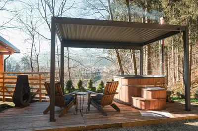 a gazebo with a table and chairs on a deck at Hiska Na Samem v Slovenj Gradcu in Slovenj Gradec