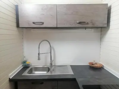 a kitchen counter with a sink and a cabinet at Počitniška hišica Patrik Terme Čatež in Mostec