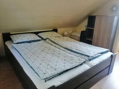 a bed with two pillows on it in a room at Počitniška hišica Patrik Terme Čatež in Mostec