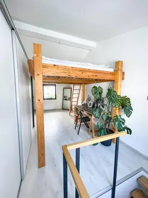 a room with a desk and a table with a plant at Apartment *MALA* in Žalec