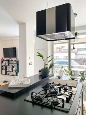 a kitchen with a black counter top with a stove at Apartment *MALA* in Žalec