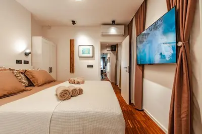 a bedroom with a bed with towels on it at SIX IN THE CITY Apartment, LJUBLJANA in Ljubljana