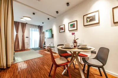 a dining room with a table and chairs at SIX IN THE CITY Apartment, LJUBLJANA in Ljubljana