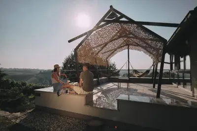 two people sitting on the edge of a building at Holiday house Podhamer Marijan in Ljutomer