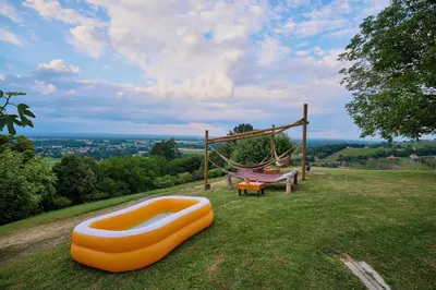an orange infront of a hammock and a swing at Holiday house Podhamer Marijan in Ljutomer