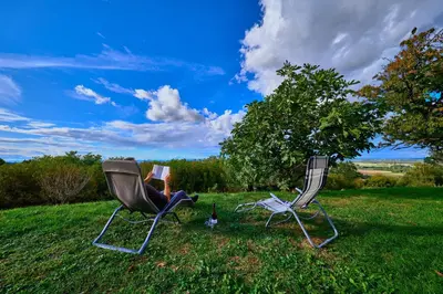 two chairs sitting in the grass in a field at Holiday house Podhamer Marijan in Ljutomer