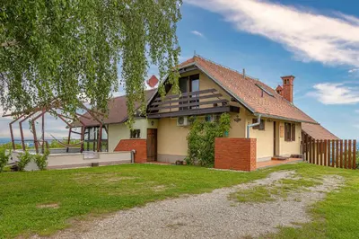 a house with a fence and a yard at Holiday house Podhamer Marijan in Ljutomer