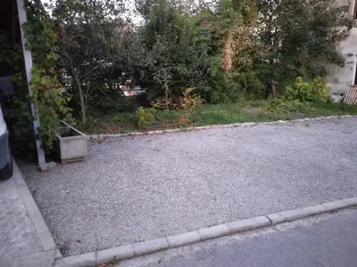 an empty parking lot with a box on the side of the road at Apartment Lan in Homec