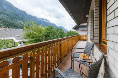 a balcony with two chairs and a bowl of food at Karavanke Holiday Getaway in Hrušica