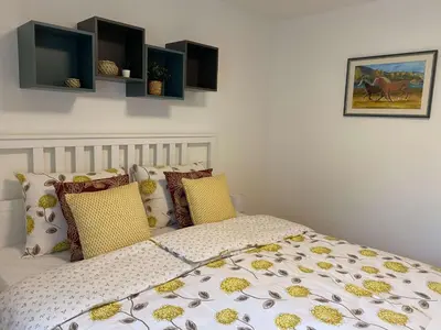 a bedroom with a bed with yellow pillows at Karavanke Holiday Getaway in Hrušica