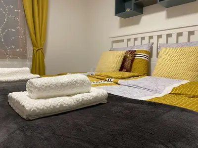 a bedroom with two beds with pillows on the floor at Karavanke Holiday Getaway in Hrušica