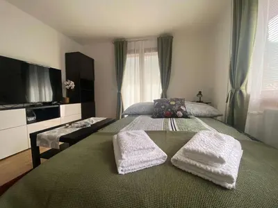 a bedroom with a bed with two towels on it at Karavanke Holiday Getaway in Hrušica