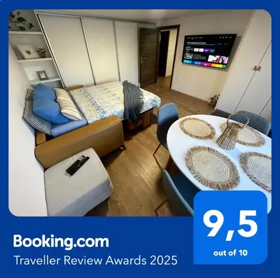 a room with a bed and a table and a couch at Home-in apartma in Ljubljana