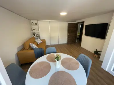 a living room with a table and a couch at Home-in apartma in Ljubljana