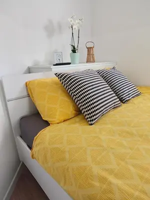 a bed with two pillows on top of it at Home-in apartma in Ljubljana