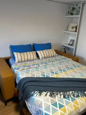 a bedroom with a bed with blue pillows at Home-in apartma in Ljubljana