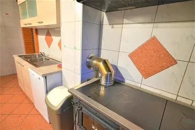 a kitchen with a sink and a faucet at Kmetija Podobnik in Idrija