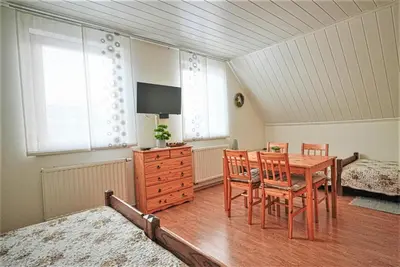 a dining room with a table and chairs at Kmetija Podobnik in Idrija
